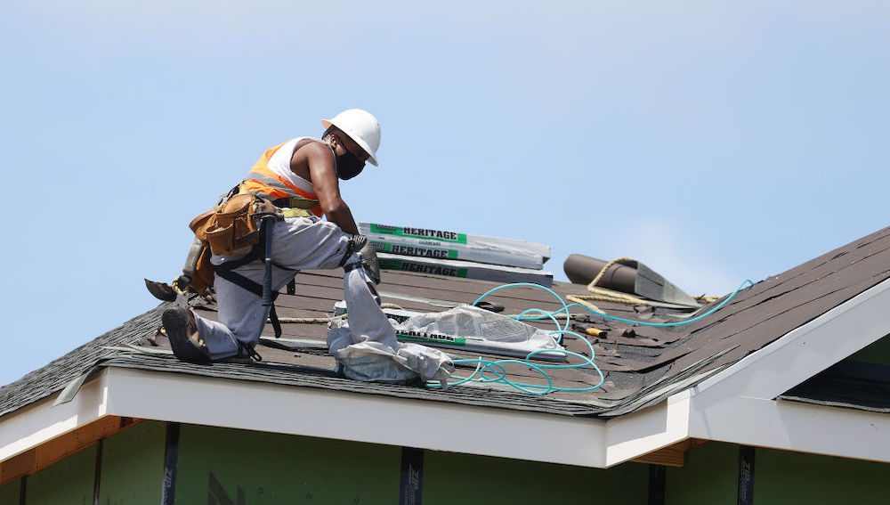 Construction worker on roof for new construction