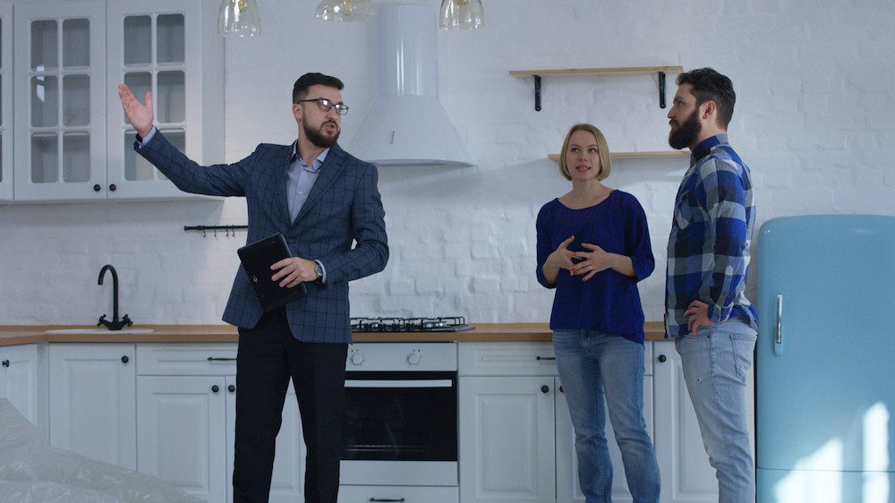 Couple in kitchen with real estate agent