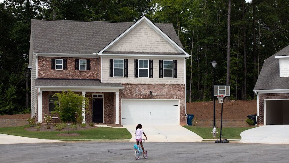 A girl rides her bike inside a community of rental homes owned by American Homes 4 Rent in suburban Atlanta.